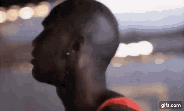 a close up of a man 's head with a blurred background .