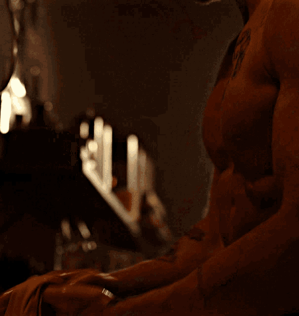 a man without a shirt has a tattoo on his arm that says ' i love you ' on it