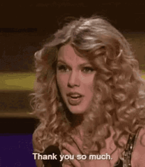 a woman with curly hair is saying thank you so much