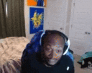 a man wearing headphones is sitting in a bedroom
