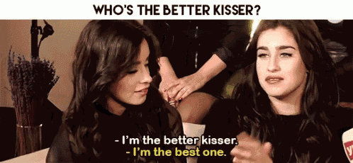 two women are sitting next to each other and one of them says " who 's the better kisser ? "