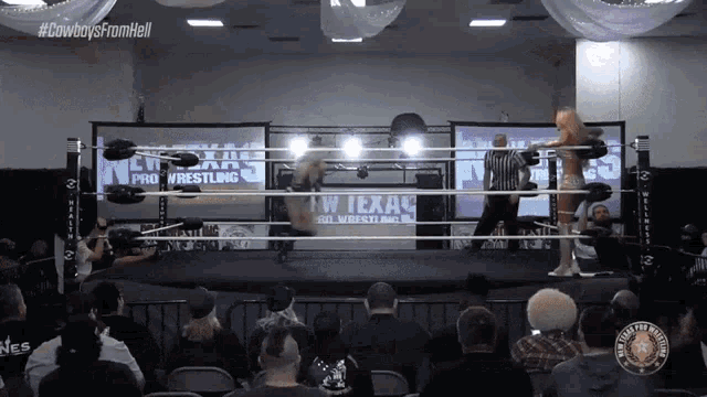 a wrestling ring with a texas pro wrestling logo on the wall