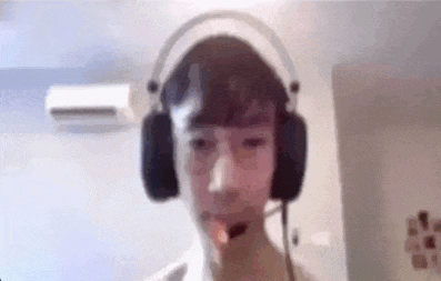 a young man wearing headphones is smoking a cigarette .