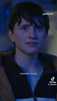 a close up of a man 's face with the words resident alien written on the bottom .