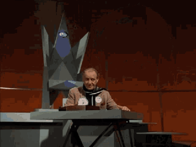 a man standing in front of a set of stairs holding a piece of paper