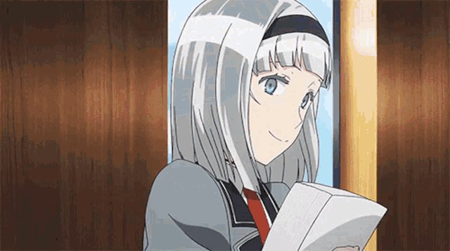 a girl with white hair and blue eyes is holding a piece of paper in her hand .