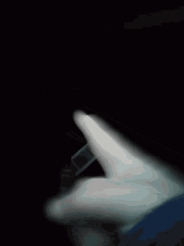 a blurry picture of a person 's face with a dark background