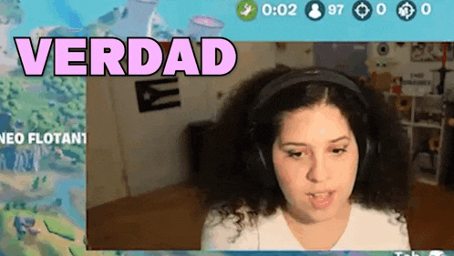 a woman wearing headphones is playing a video game with the words verdad written above her