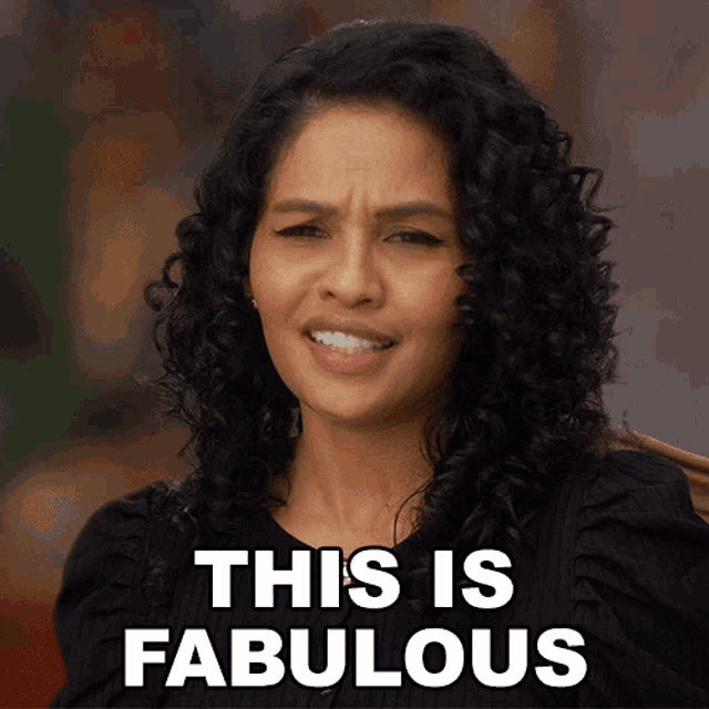 a woman with curly hair says " this is fabulous " in front of her face