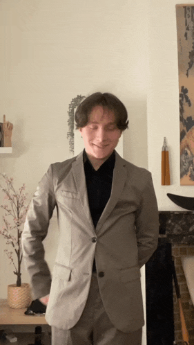 a man in a suit is standing in a room