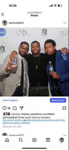 a group of men are posing for a picture with bottles of royal blue