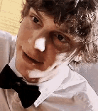 a man wearing a white shirt and a black bow tie