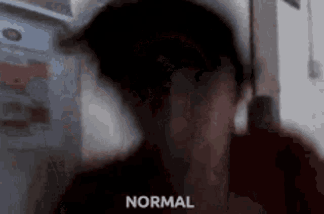 a blurry picture of a person with the word normal written in the corner