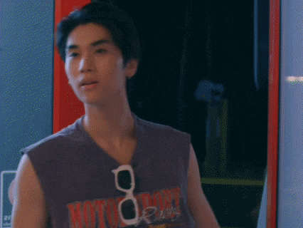 a young man wearing sunglasses and a purple tank top that says motorcycle on it