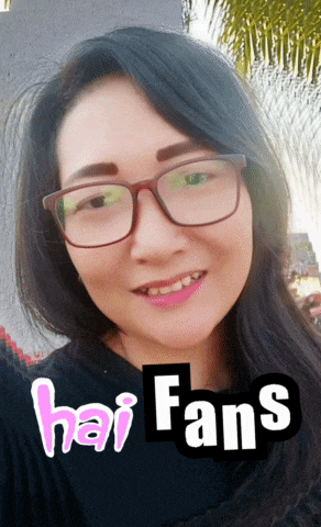 a woman wearing glasses and a black shirt with hai fans written in pink
