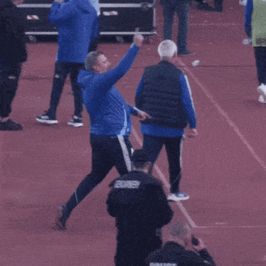 a blurred image of people walking on a track