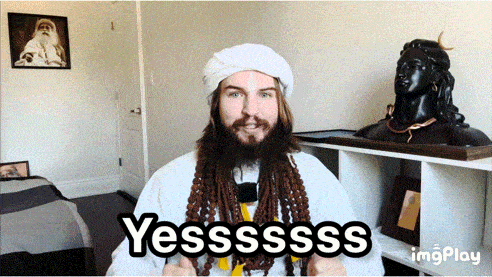 a man with dreadlocks is giving a thumbs up and says yesssss