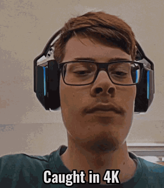 a man wearing glasses and headphones has the words caught in 4k above his head