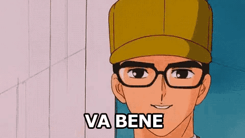 a man wearing glasses and a baseball cap is smiling and says va bene
