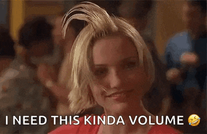 a woman with her hair in a bun is smiling and says `` i need this kinda volume '' .