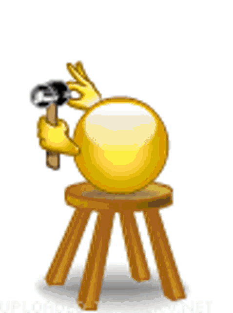 a smiley face is sitting on a wooden stool