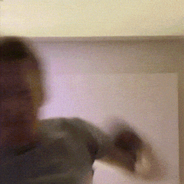 a blurry picture of a man 's face and arms