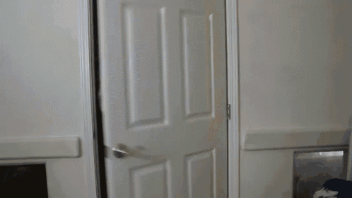 a person is standing in a doorway with their hand on their face