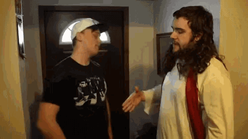 a man in a jesus costume talks to another man in a black shirt