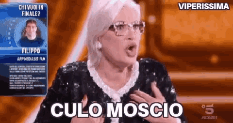 a woman wearing glasses says " culo moscio " on a tv show