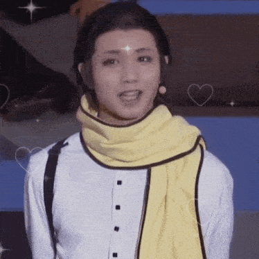 a man wearing a white shirt and a yellow scarf with hearts around him