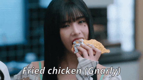 a woman eating fried chicken with the words fried chicken gnarly