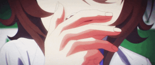 a close up of a woman covering her mouth with her hands