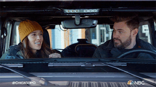 a man and a woman are sitting in a car with the hashtag #chicagopd
