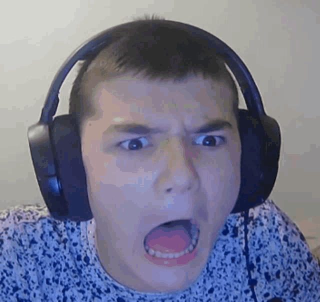 a man wearing headphones is making a funny face