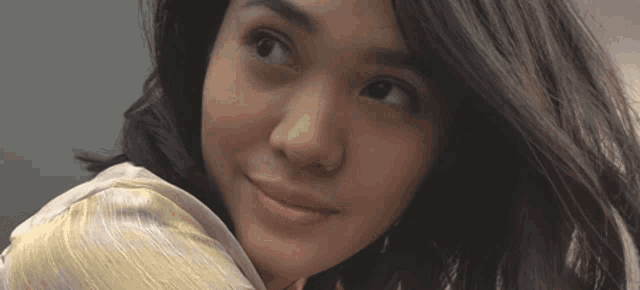 a close up of a woman 's face looking up
