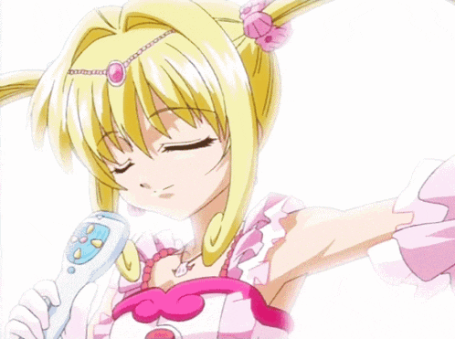 a girl in a pink dress is holding a microphone in her hand