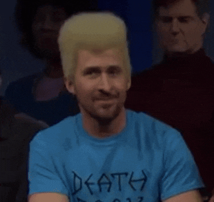 a man with blonde hair and a beard is wearing a blue t-shirt with the word def written on it .