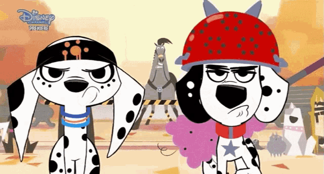 two dalmatian dogs standing next to each other with disney written on the bottom