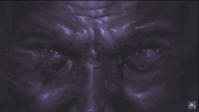 a close up of a person 's eye with a purple glow
