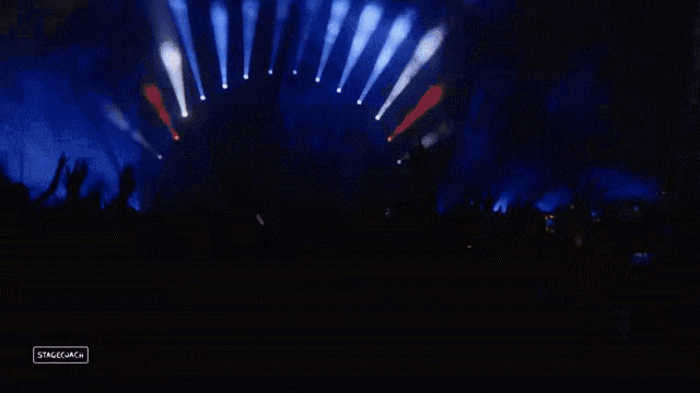 a crowd of people at a concert with a sign that says stagemagic