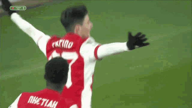 a soccer player with the number 87 on his jersey is being tackled by another player