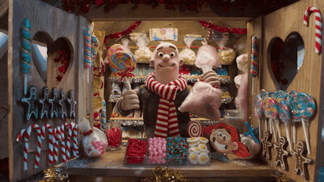 a man in a scarf is selling cotton candy in a store