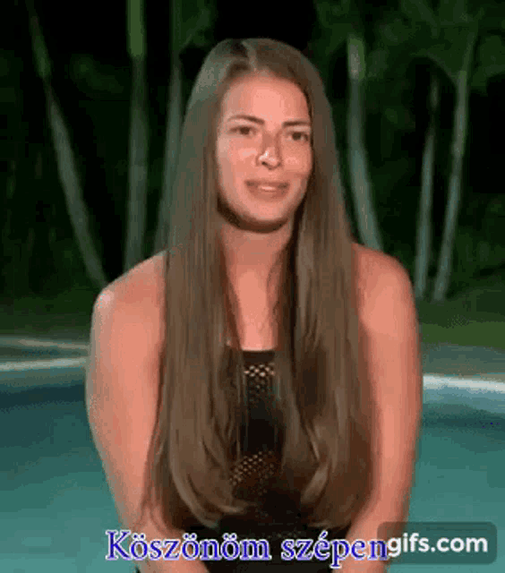 a woman with long hair is standing in front of a pool with a watermark that says koszonom szpengifs.com on it