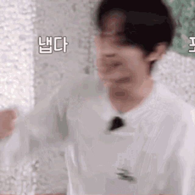 a blurry picture of a man in a white shirt and tie .