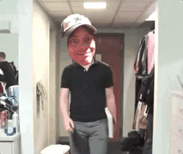 a man wearing a hat with a star on it is standing in a hallway