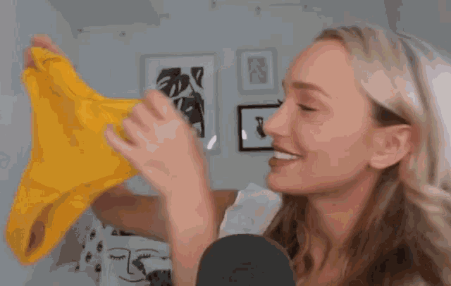 a woman is holding a yellow triangle in her hand