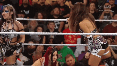 a woman in a wrestling ring with the word usa on the screen