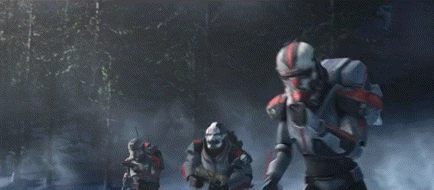 two stormtroopers are standing next to each other in a forest .