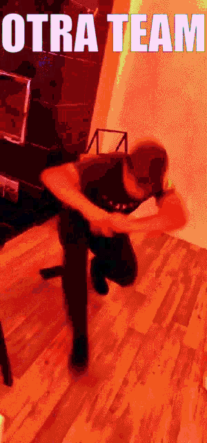 a man is kneeling down in front of a chair with the words otra team above him