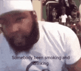 a man with a beard wearing a white shirt says somebody been smoking and drinking .